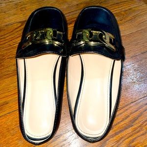 Black patent leather slides with gold chain embellishment